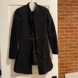 BCBG formal jacket. Black with a ruffle detail all over. hugs the waistline.